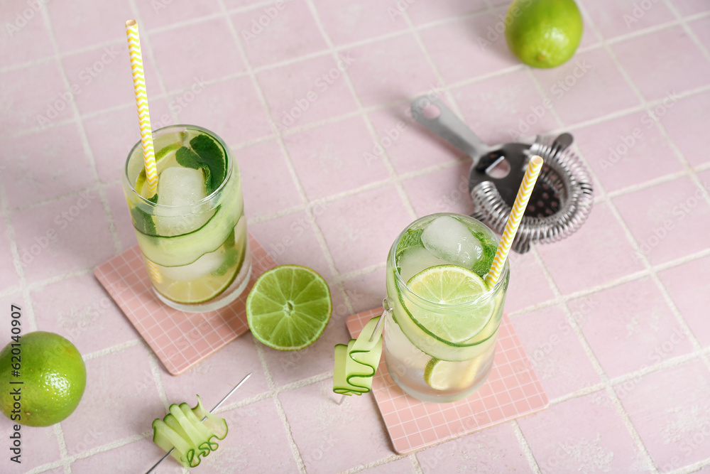 Glasses of mojito with cucumber on tile table