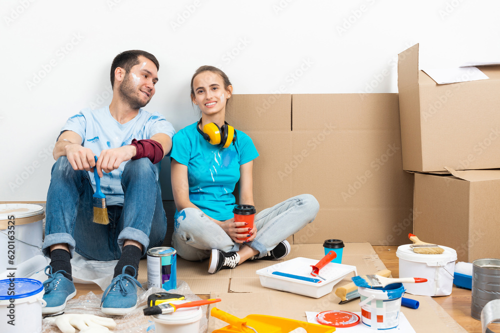 Happy couple together sitting on floor