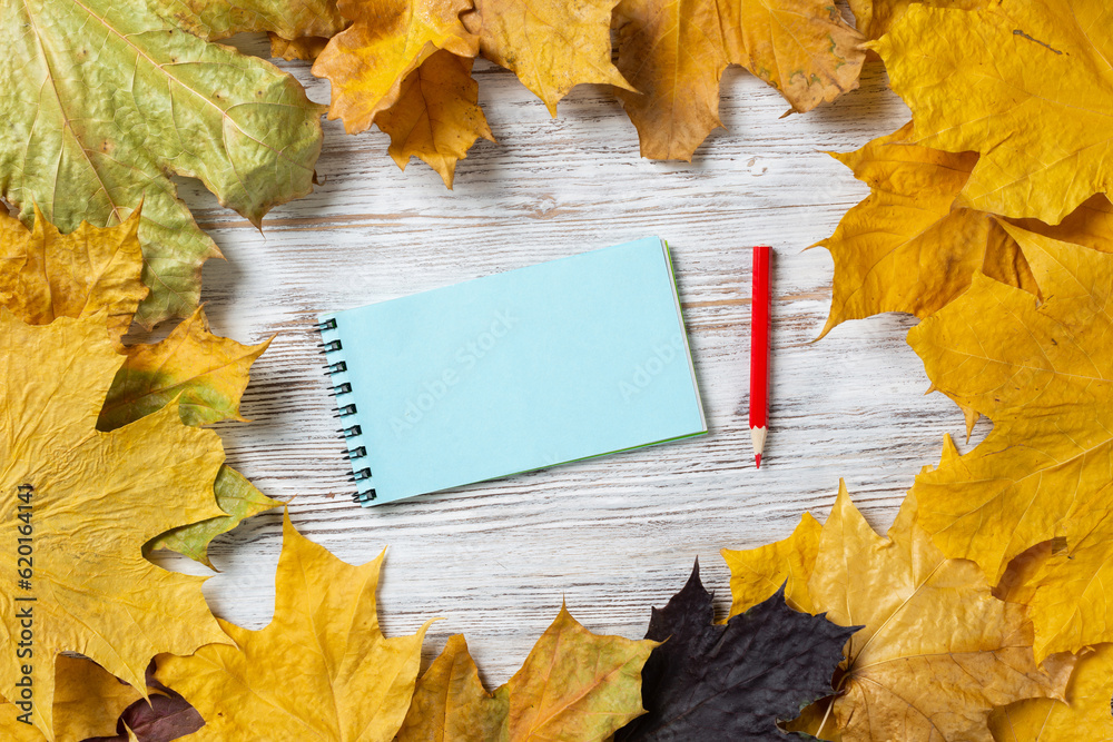 Spiral notepad and pen lies on vintage wooden desk