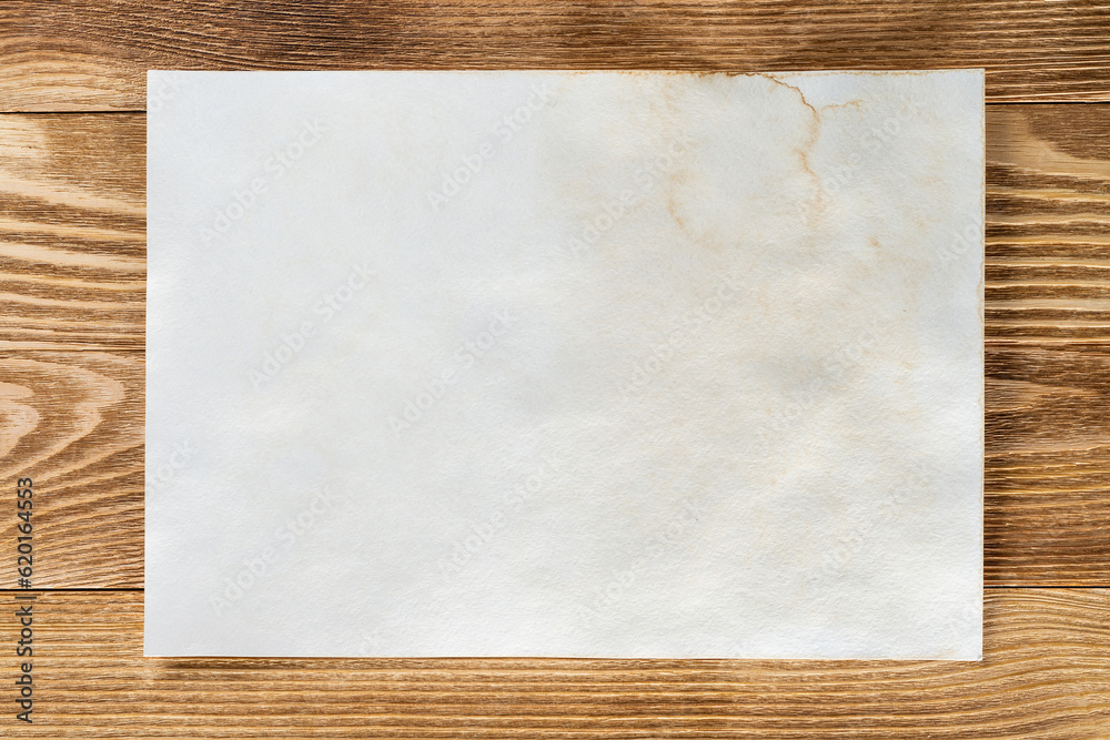 Sheet of paper lying on wooden table