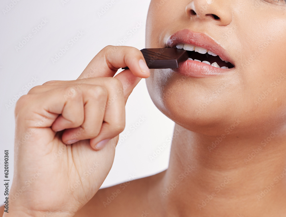 Chocolate, bite and mouth of woman with sweets in studio eating luxury food, treats and candy. Sugar