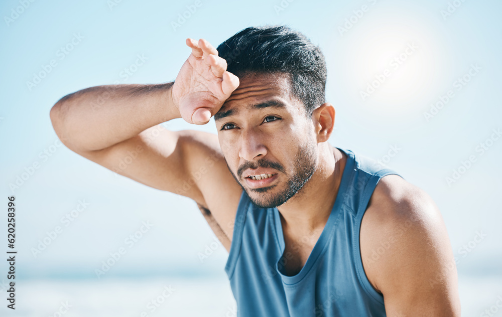 Fitness, sweating and man breathing at the beach after training, running and intense cardio, focus a