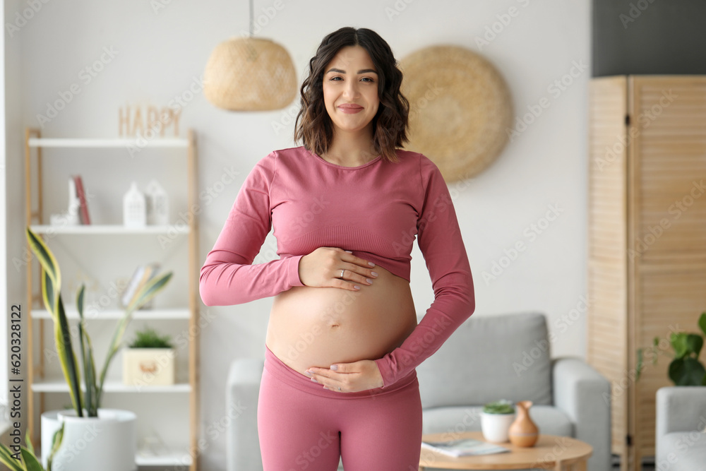 Sporty pregnant woman at home