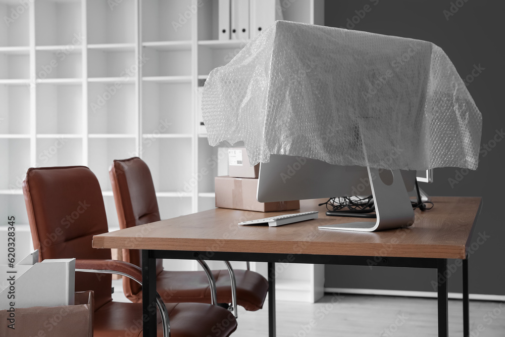 Workplace with cardboard boxes in office on moving day