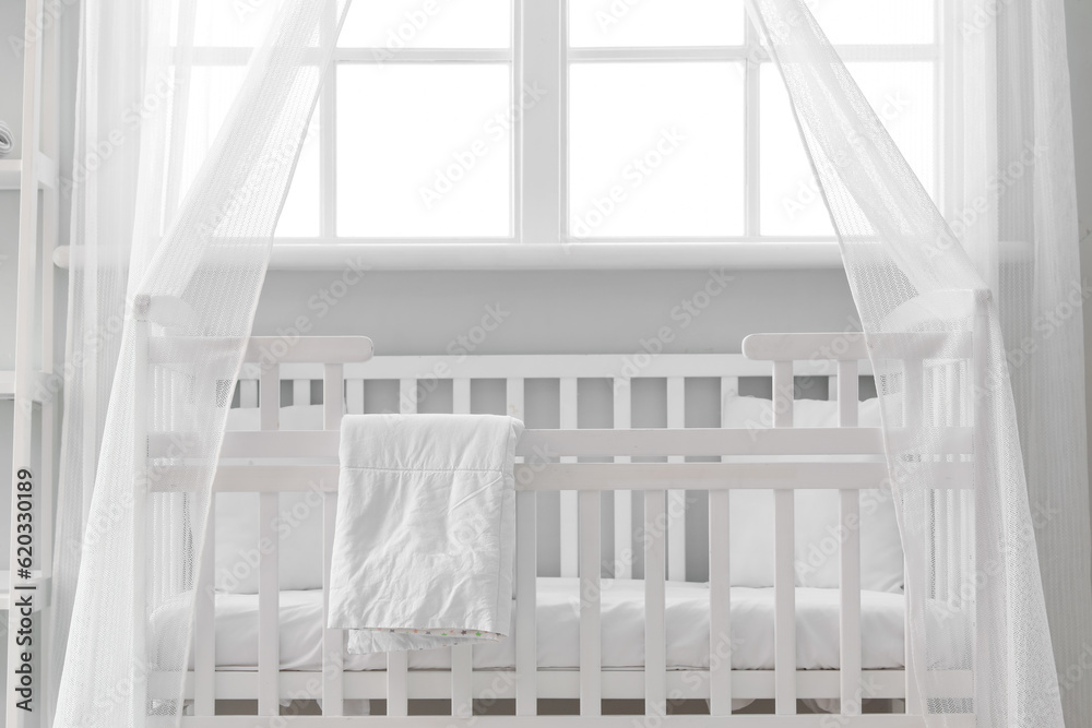 Interior of stylish childrens bedroom with crib