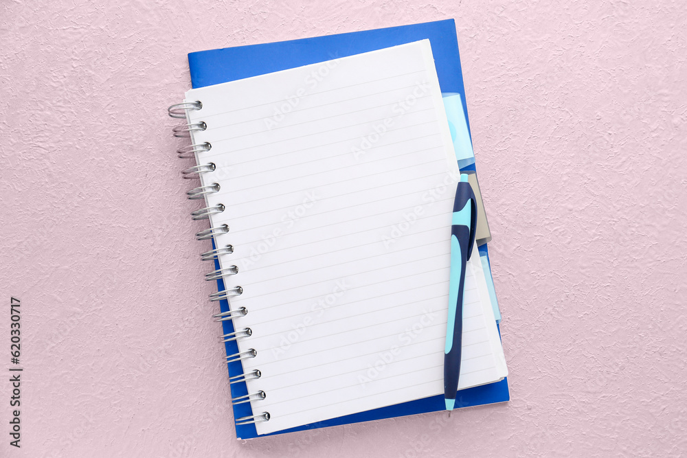 Blank notebook and pen on light background