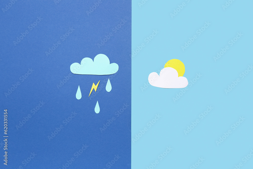 Paper clouds with rain drops, lightning and sun on blue background. Weather forecast concept