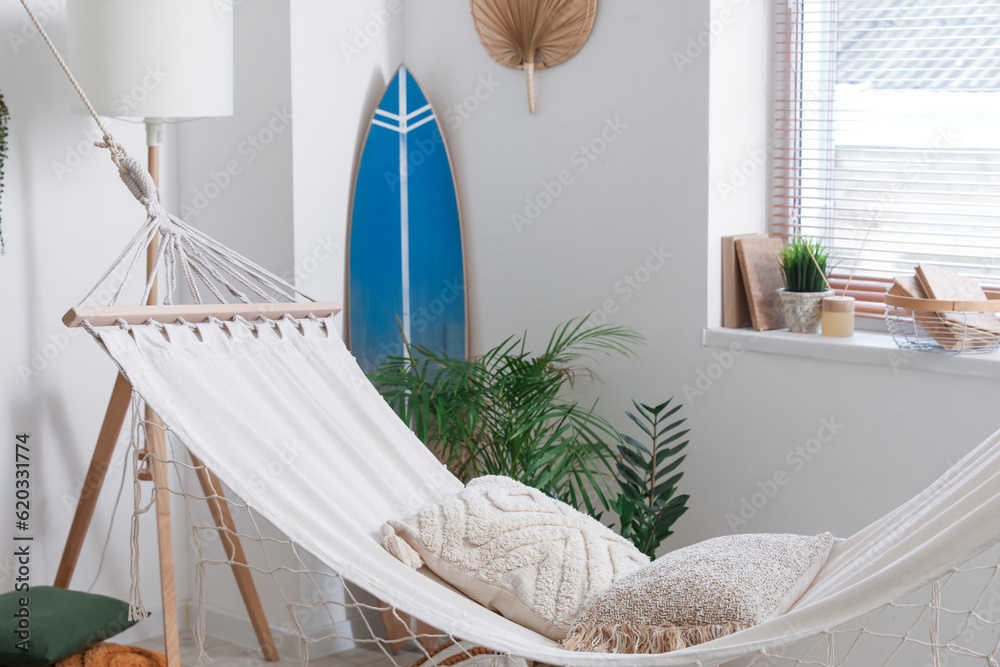 Cozy hammock with cushions in interior of living room