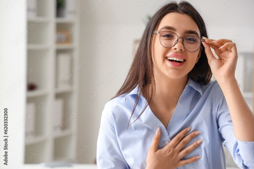 Beautiful young woman wearing glasses in office