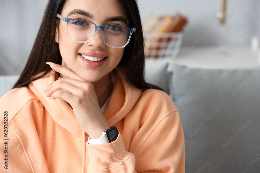 Beautiful young woman wearing glasses at home