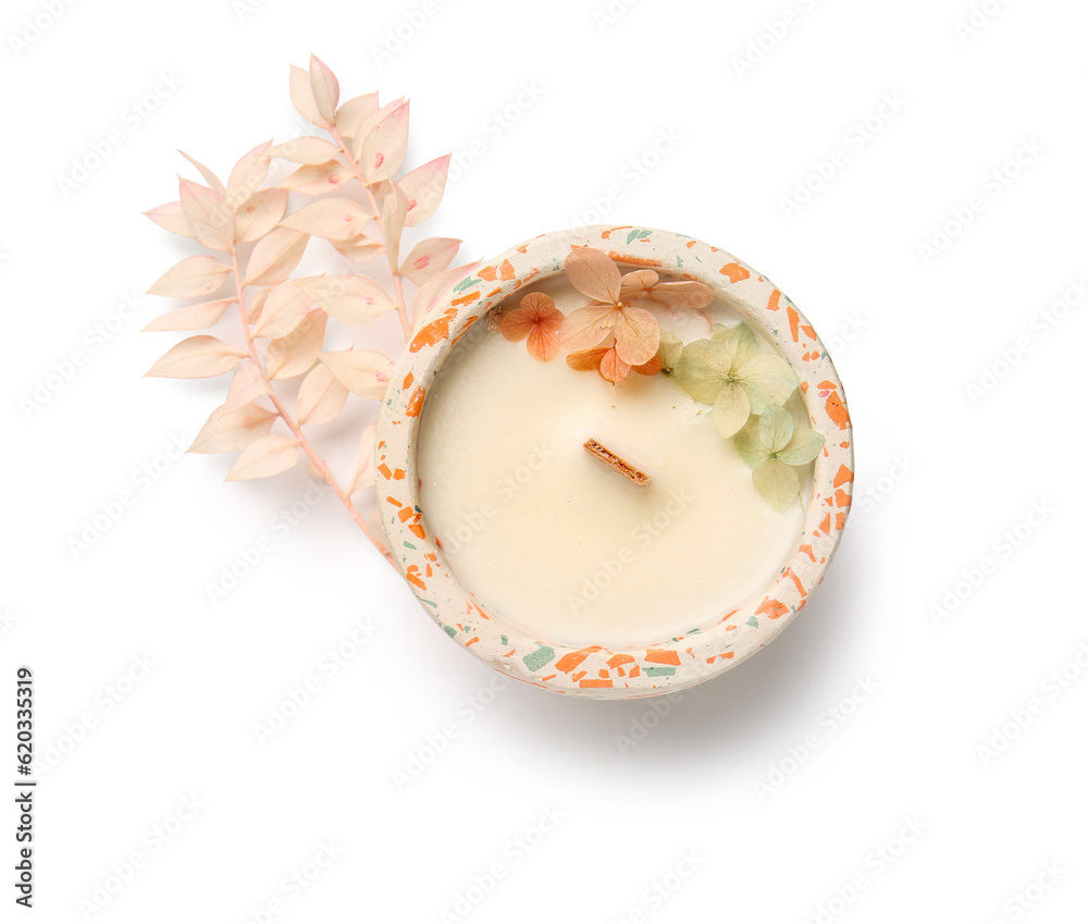 Holder with candle and flowers on white background