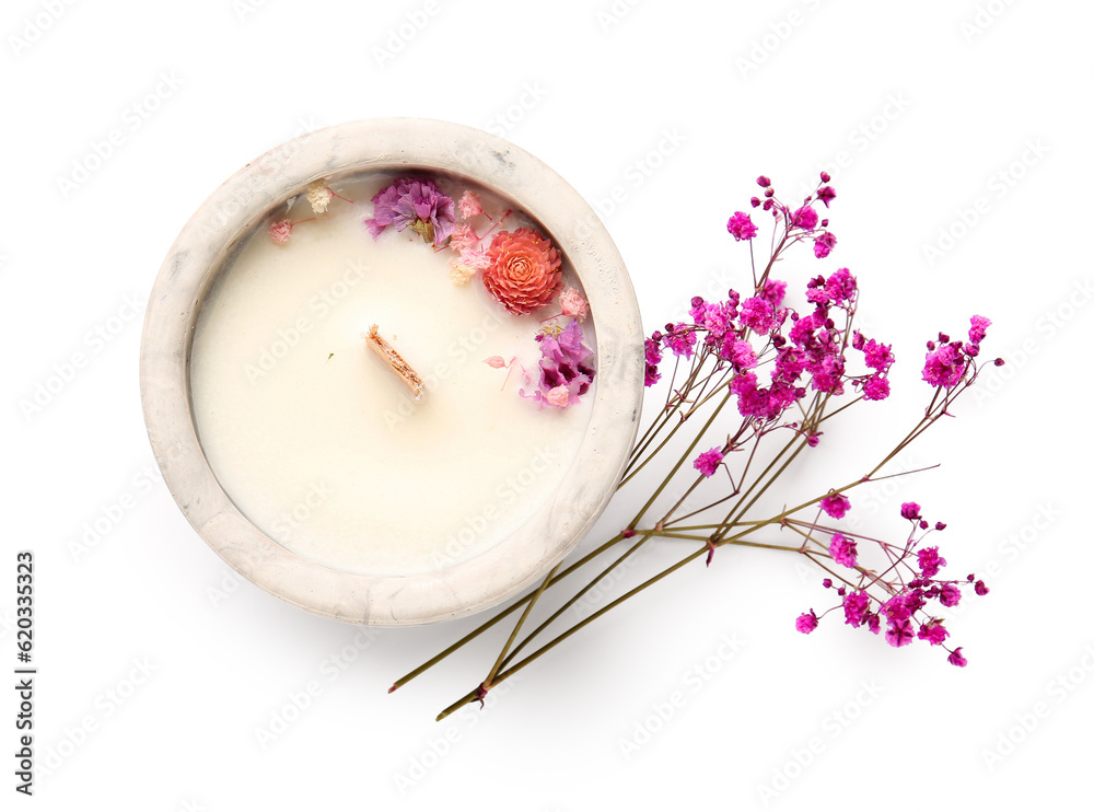 Holder with candle and flowers on white background