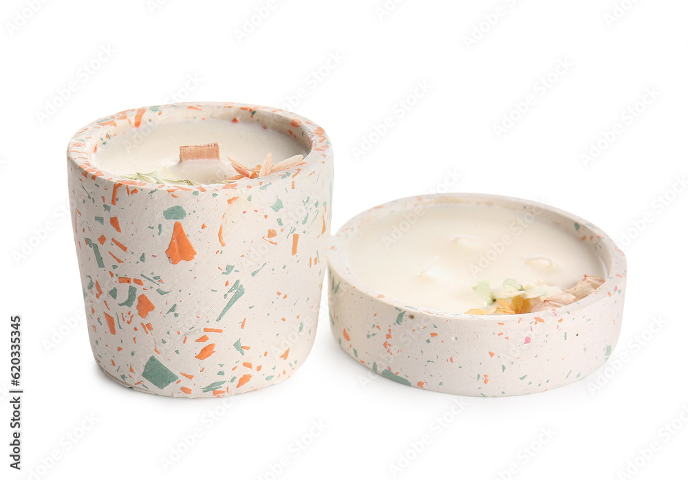 Holders with candles on white background