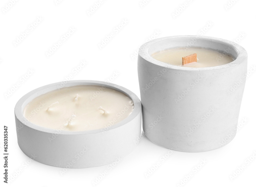 Holders with candles on white background