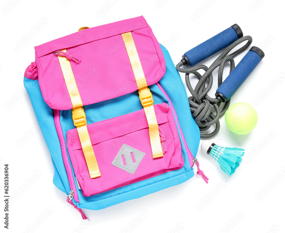 Backpack with badminton shuttlecock, skipping rope and tennis ball isolated  on white background