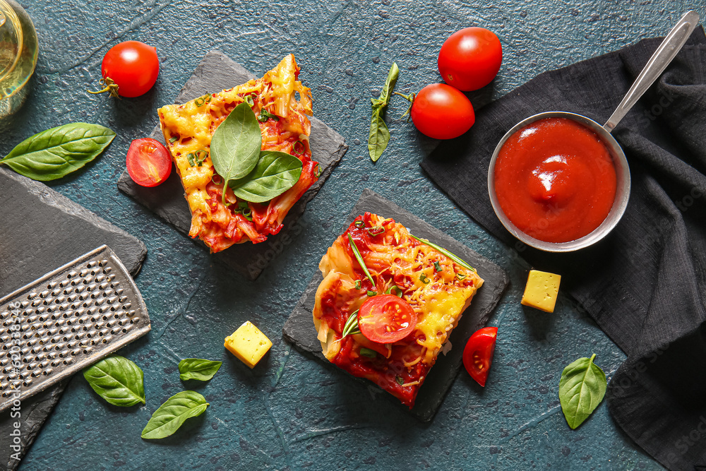 Boards of pasta with tomato sauce and cheese on dark background