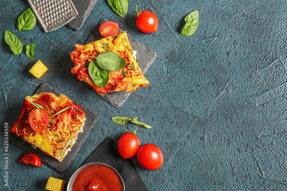 Boards of pasta with tomato sauce and cheese on dark background