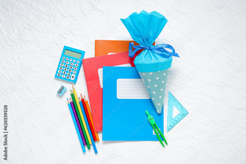 Blue school cone with different stationery on white background