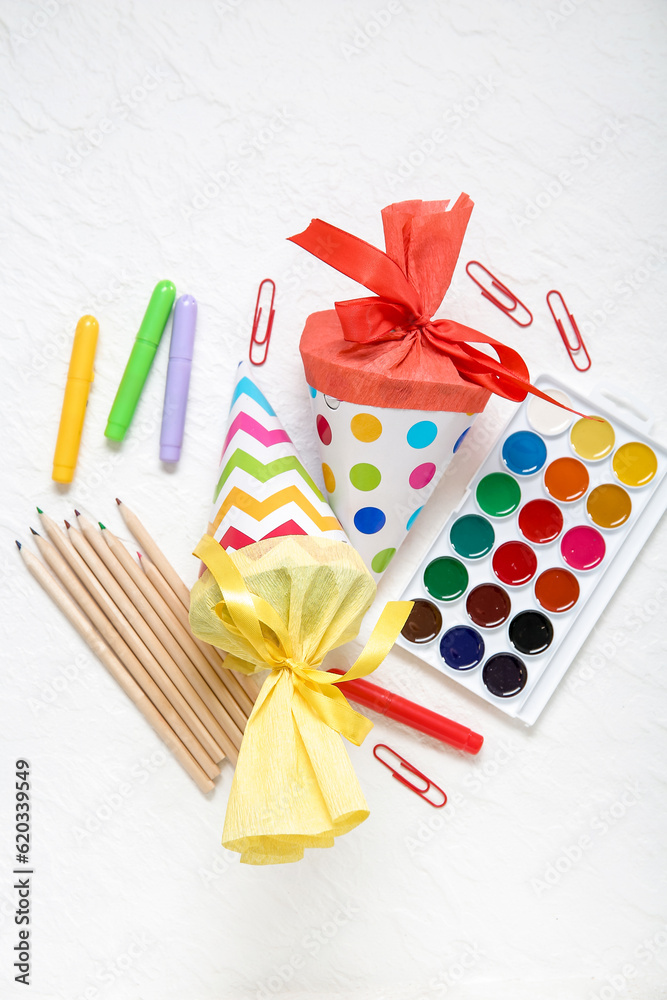 Colorful school cones with different stationery on white background