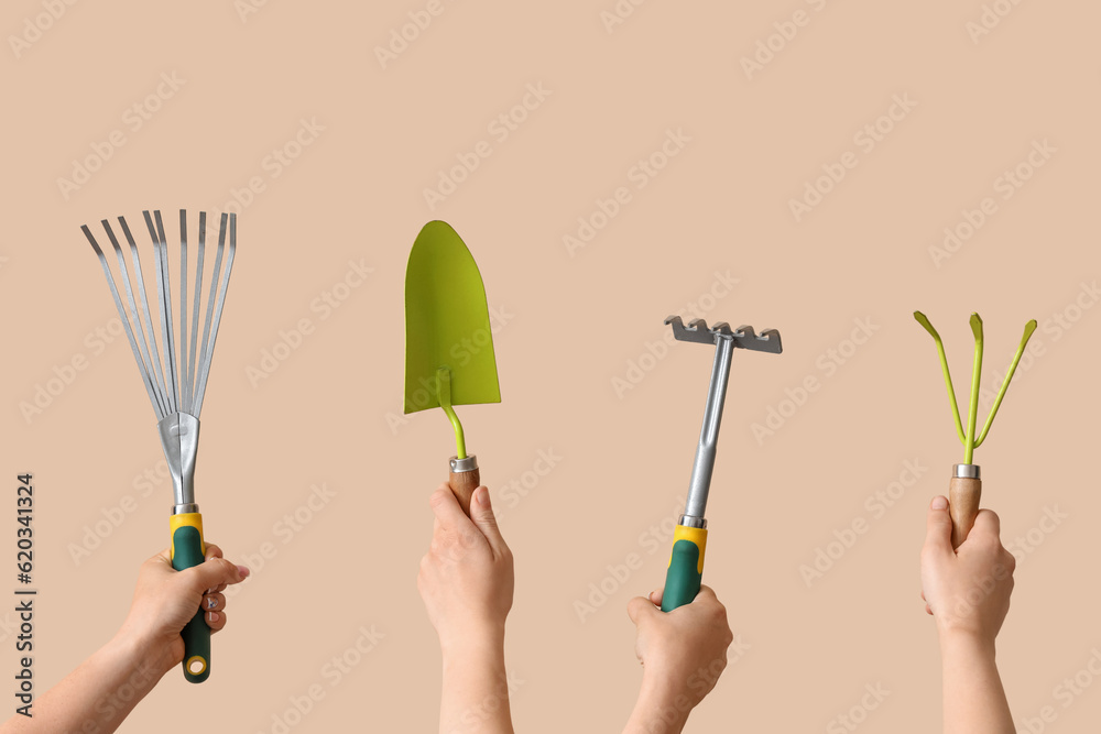 Women with gardening tools on beige background