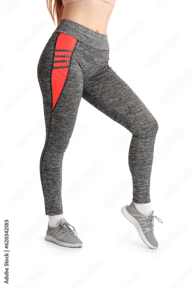 Sporty young woman in leggings on  white background