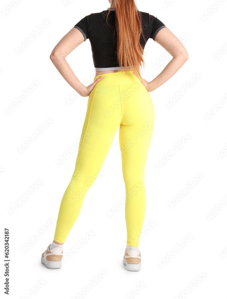 Young woman in sportswear on white background, back view