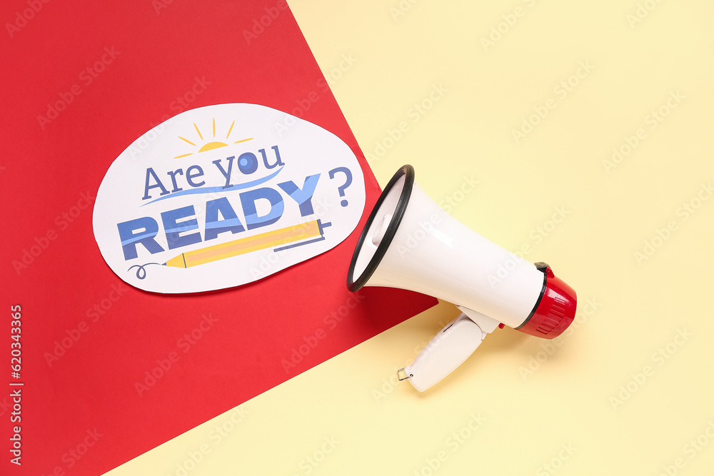 Megaphone and sheet with question ARE YOU READY? on color background