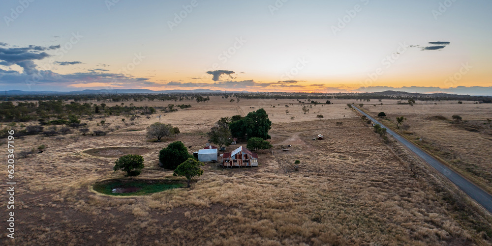 Road across cattle grazing farmland near Rockhampton, Queensland, Australia