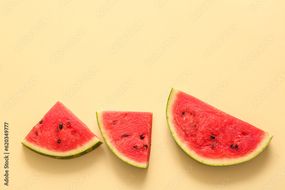 Pieces of fresh watermelon on yellow background