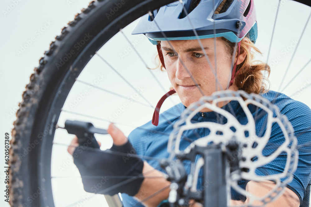 Bike repair, focus and a man with a wheel in nature for a change, mechanic or travel for sports. Ser