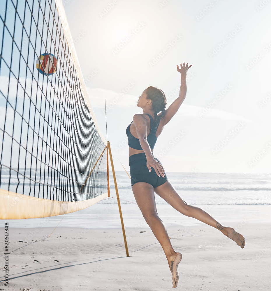 Woman, jump and volleyball on beach by net in serious sports match, game or competition. Body of fem