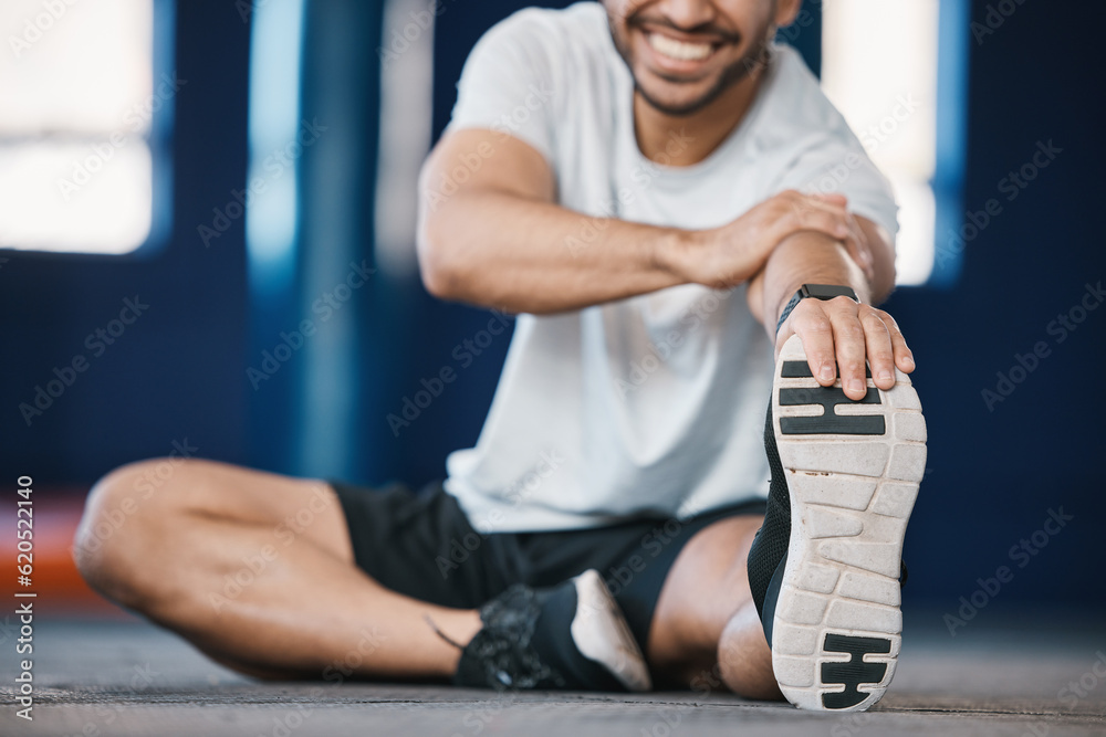 Foot, exercise and stretching with a sports man in the gym getting ready for a cardio training routi