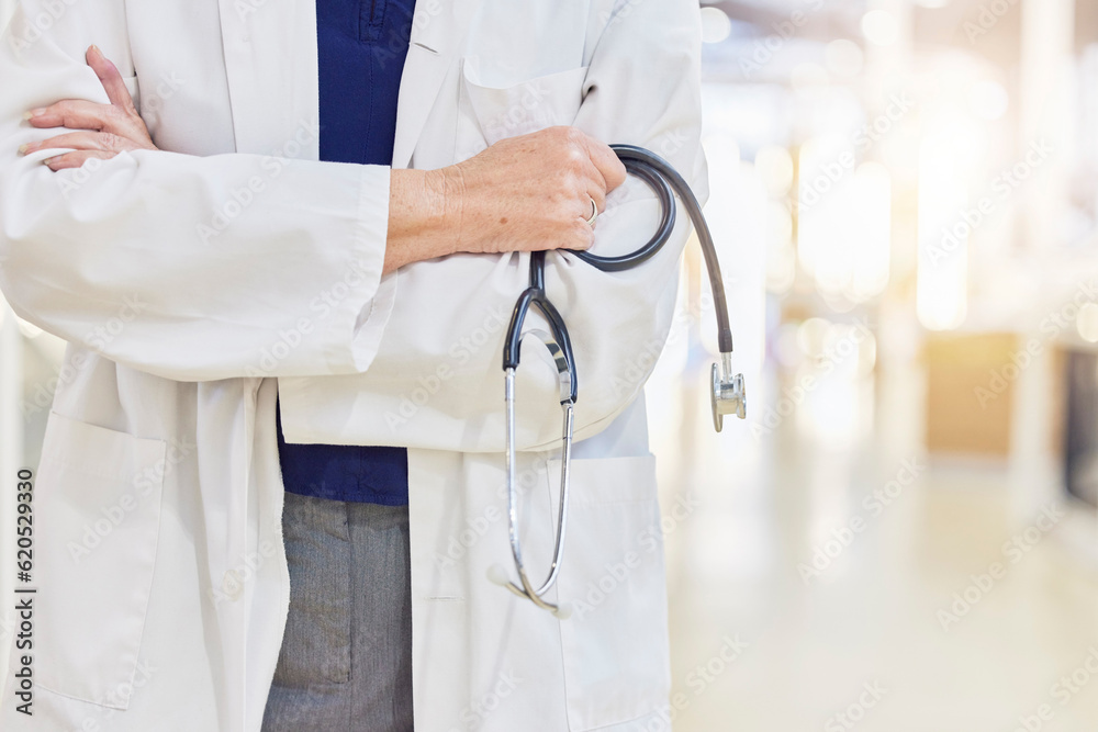 Hands, arms crossed and doctor with stethoscope for cardiology, healthcare or wellness in hospital. 