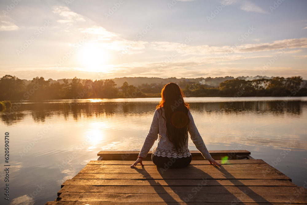 Young woman sitting on the pier