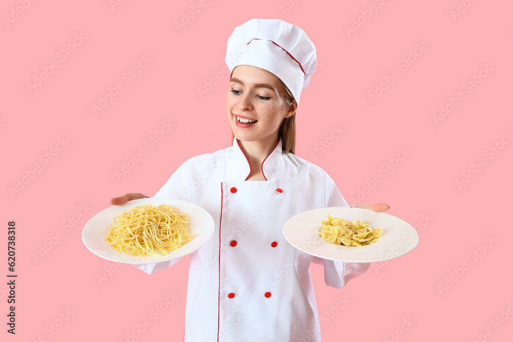 Female chef with plates of tasty pasta on pink background