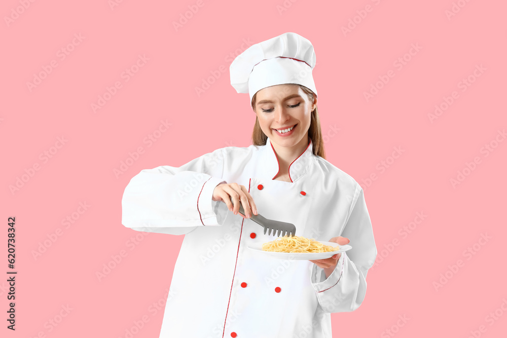 Female chef with tasty pasta on pink background