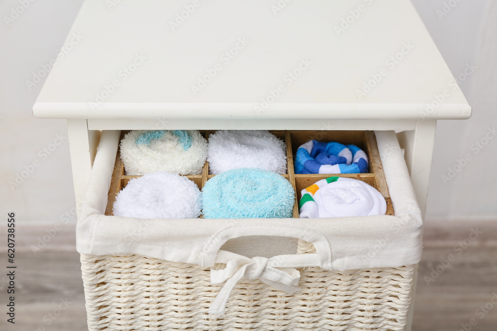 Drawer with basket of different socks, closeup