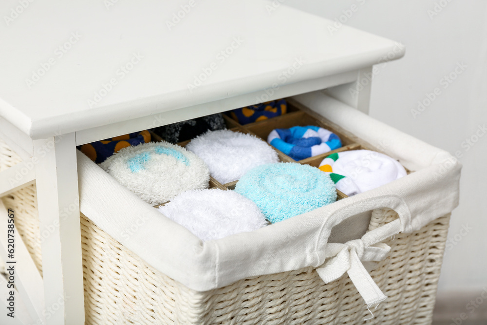 Drawer with basket of different socks, closeup