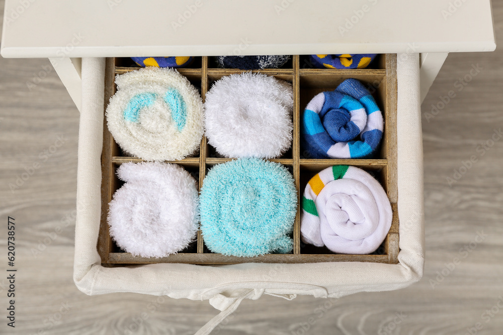 Drawer with basket of different socks in room, closeup