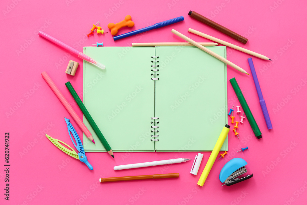 Blank notebook with different stationery on pink background