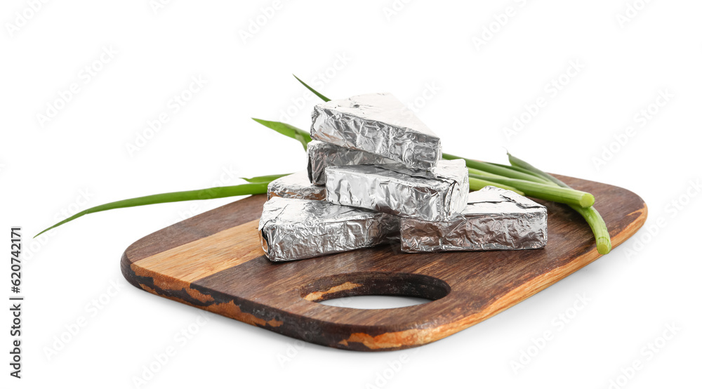 Board with triangles of tasty processed cheese in foil and onion on white background