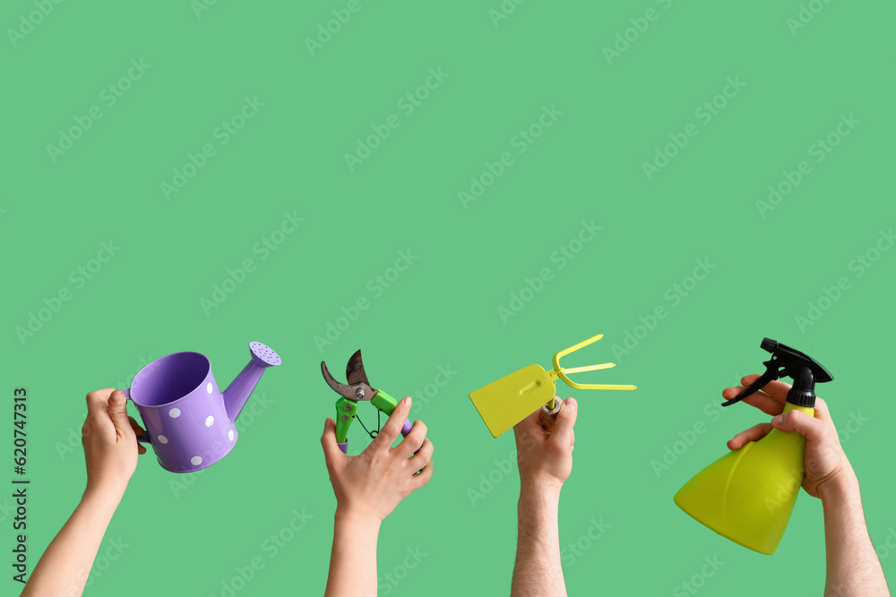 People with gardening tools on green background