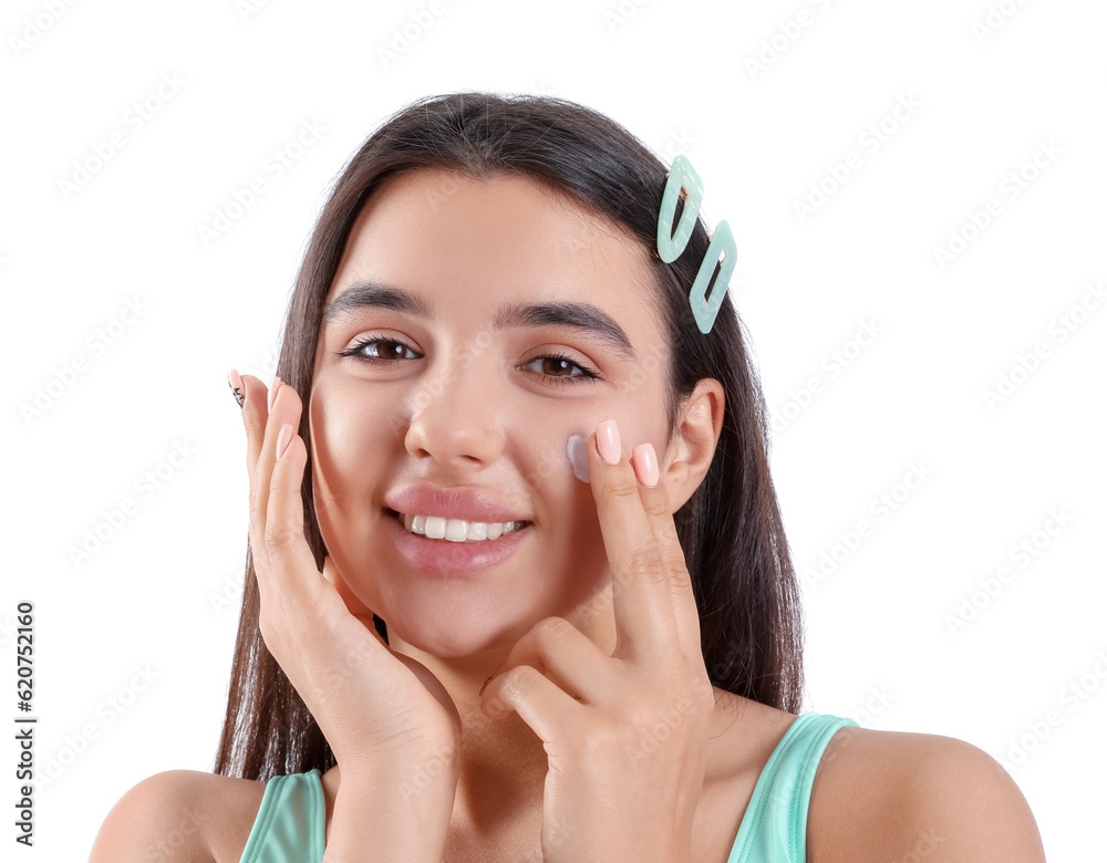 Beautiful young woman applying sunscreen cream on white background, closeup