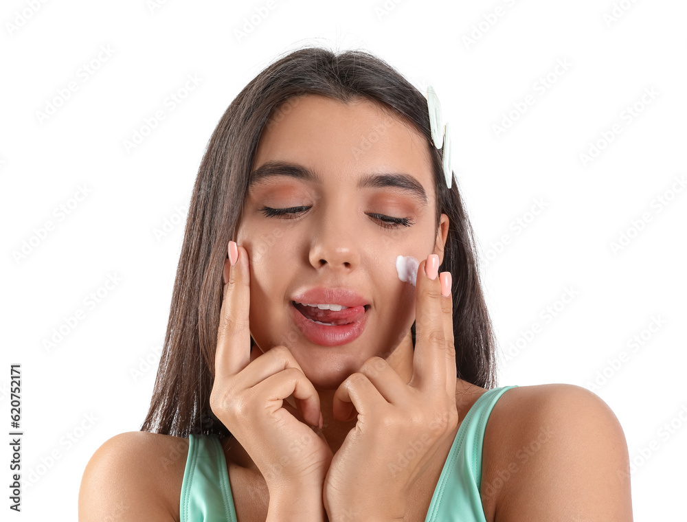 Beautiful young woman applying sunscreen cream on white background, closeup