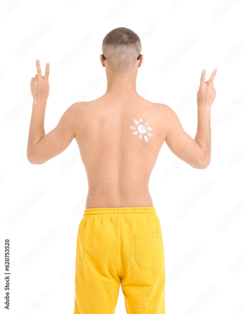 Young man with sun made of protection cream on his body showing victory gesture against white backgr