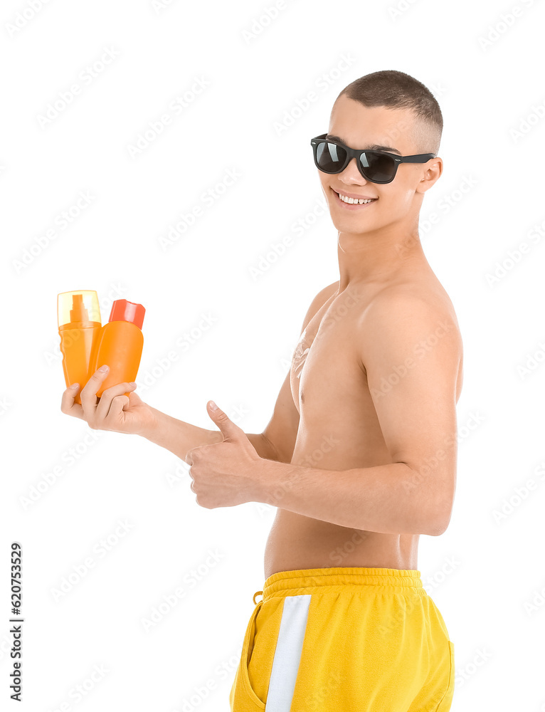 Happy young man with bottles of sunscreen cream showing thumb-up gesture isolated on white backgroun