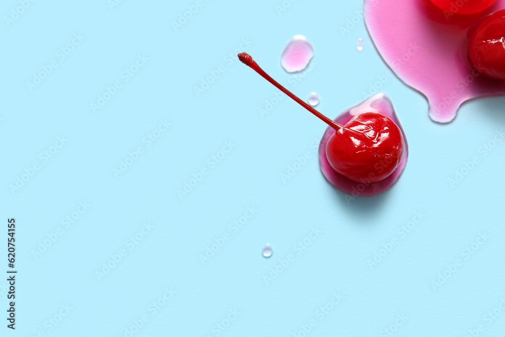 Tasty maraschino cherries on blue background