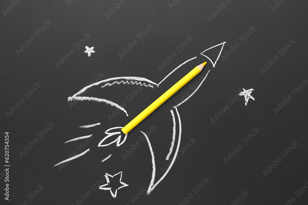 Drawn rocket with pencil on black background