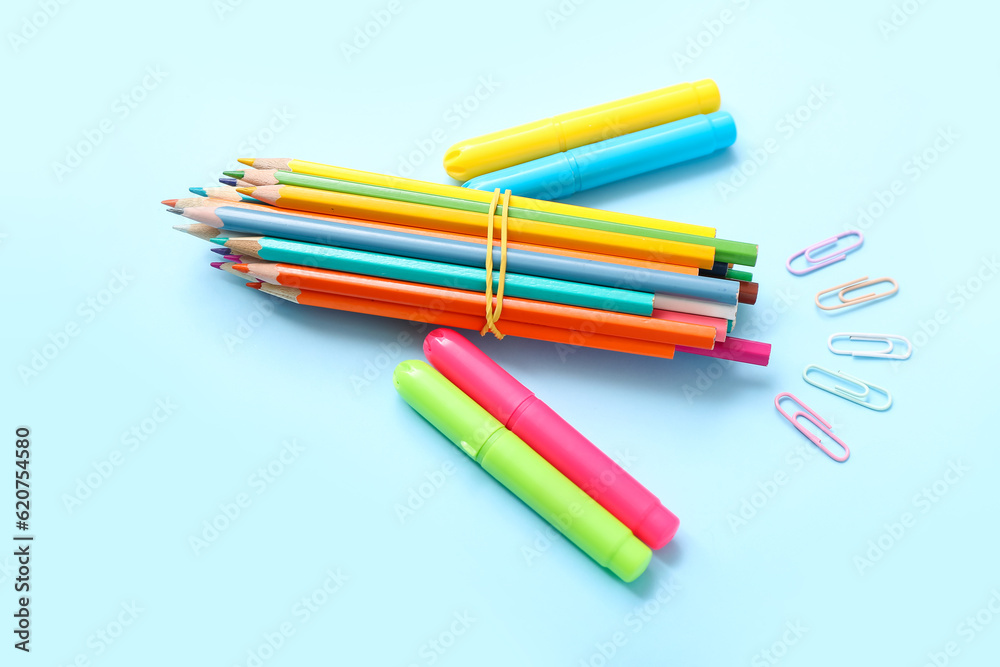 Rocket made of stationery on light blue background