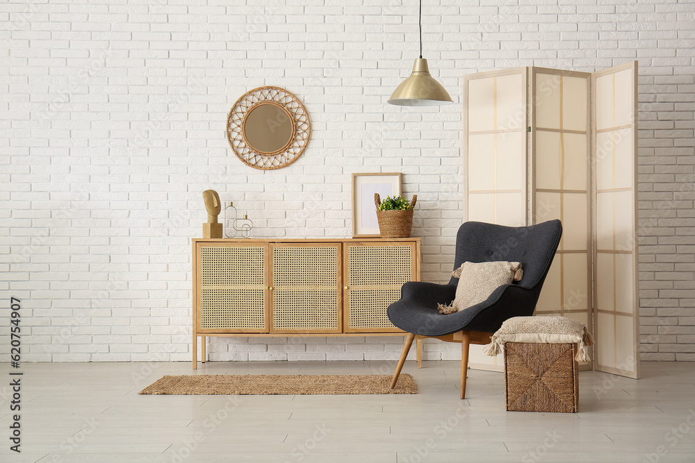 Modern living room interior with black armchair, cabinet and folding screen